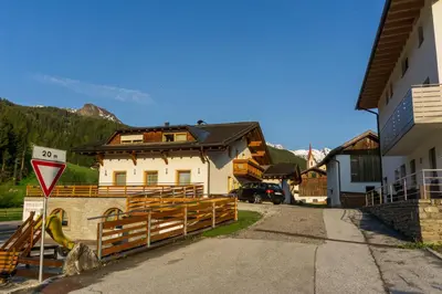 a building with a gate in front of a street at Home in the Alps in Racines
