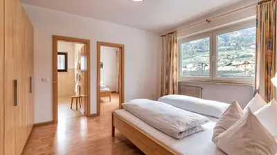 a bedroom with a bed and a large window at Residence Andrea in Lagundo