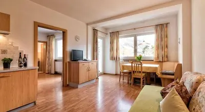 a living room with a kitchen and a dining room at Residence Andrea in Lagundo