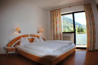 a bedroom with a bed with a large window at Residence Andrea in Lagundo