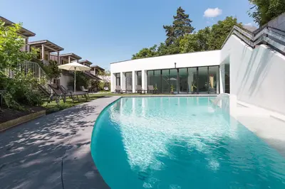 a swimming pool in front of a house at Botango in Parcines