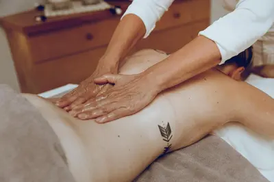 a man getting a massage from a therapist at Botango in Parcines