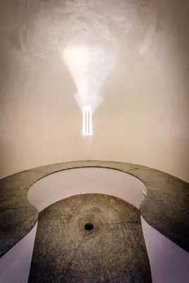 a room with a table with a light on the ceiling at Botango in Parcines