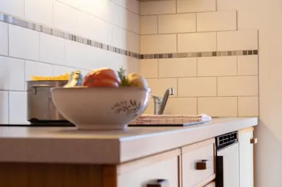 a bowl of vegetables on a counter in a kitchen at Fewo Zweiraum im Haus Götsch 4 in Parcines