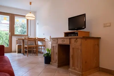 a living room with a tv on top of a wooden cabinet at Fewo Dreiraum im Haus Götsch 2 in Parcines