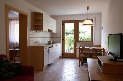 a living room with a kitchen and a dining room at Fewo Dreiraum im Haus Götsch 2 in Parcines