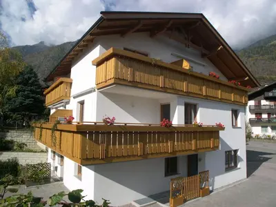 a building with wooden balconies on the side of it at Fewo Zweiraum im Haus Götsch 1 in Parcines
