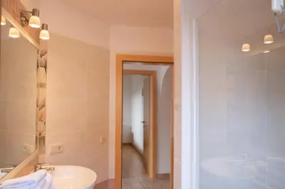 a bathroom with a sink and a shower and a toilet at Fewo Zweiraum im Haus Götsch 1 in Parcines