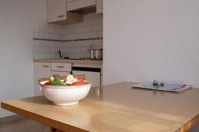 a bowl of vegetables sitting on a table in a kitchen at Fewo Zweiraum im Haus Götsch 1 in Parcines