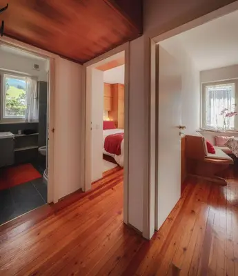 a room with a bedroom with a bed and a wooden ceiling at Cortina-House in Cortina dʼAmpezzo