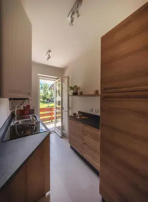 a kitchen with a sink and wooden cabinets at Cortina-House in Cortina dʼAmpezzo