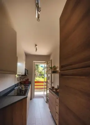 a kitchen with a door leading to a patio at Cortina-House in Cortina dʼAmpezzo