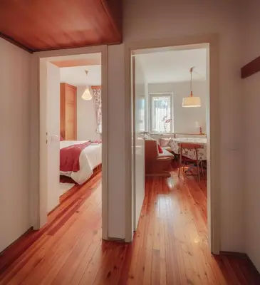 a bedroom with a bed and a dining room at Cortina-House in Cortina dʼAmpezzo