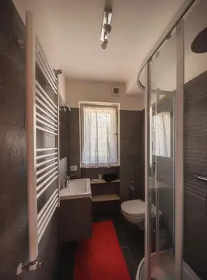 a bathroom with a toilet and a sink and a shower at Cortina-House in Cortina dʼAmpezzo