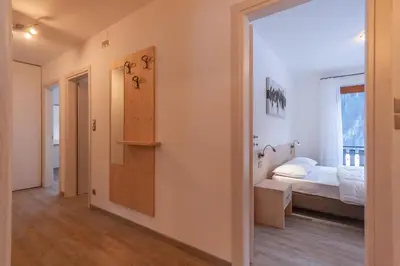 a room with a bedroom with a bed and a window at Casa Zulian in Falcade