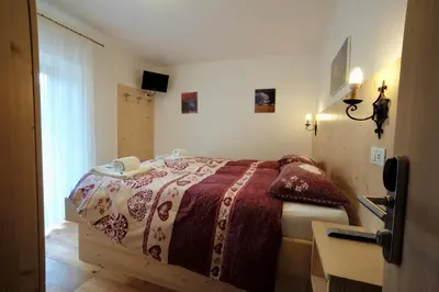 a bedroom with a bed in a room at Rifugio Palafavera in Val di Zoldo