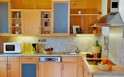 a kitchen with wooden cabinets and a microwave at Appartements Karbon in Seiser Alm