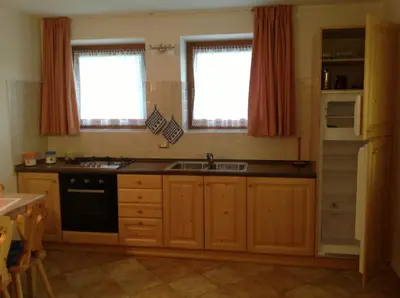 a kitchen with a sink and a stove at Appartamenti Piazzi in Tesero