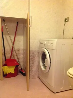 a laundry room with a washing machine in a bathroom at Appartamenti Piazzi in Tesero