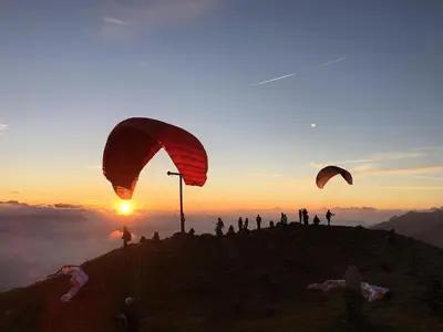 people standing on top of a mountain with hot air parachutes at Hotel Ratschingserhof in Racines