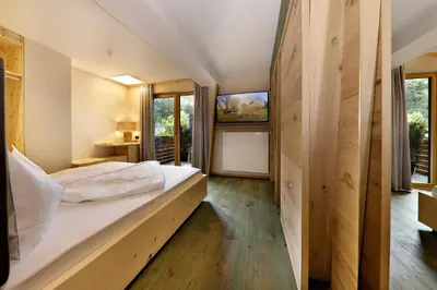 a bedroom with a large bed in a house at Hotel Ratschingserhof in Racines