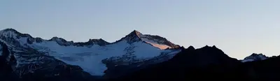 a view of a mountain with the sun shining on it at Cafe Schneider in Lappago