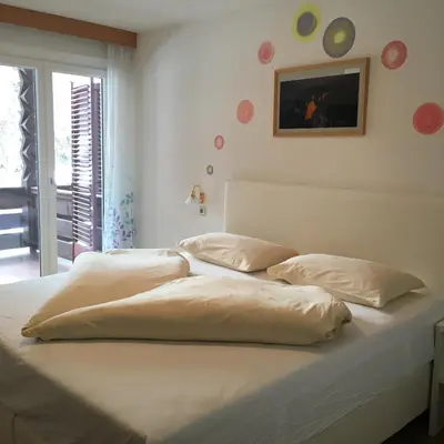 a white bed with two pillows on top of it at Burgfrieden in Vipiteno