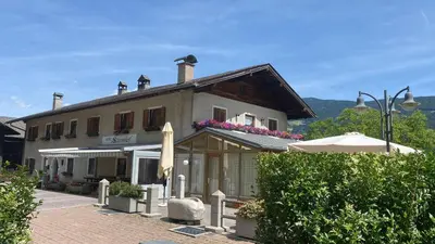 a building with an umbrella in front of it at Sturmhof in Chiusa