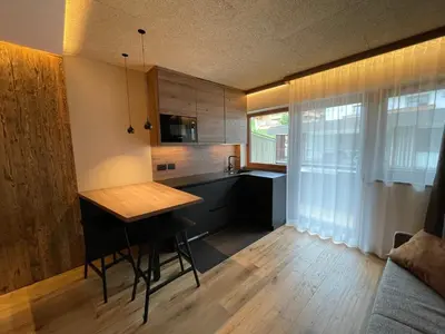 a kitchen with a table and a dining room at Residence Tantalus in San Lorenzo di Sebato