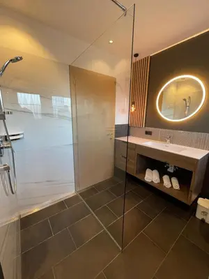 a bathroom with a shower and a sink and a mirror at Residence Tantalus in San Lorenzo di Sebato