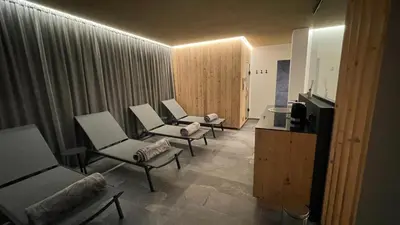 a living room with three chairs and a television at Residence Tantalus in San Lorenzo di Sebato