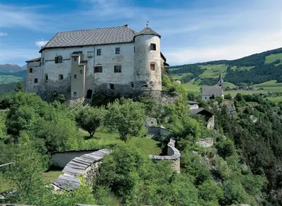 an old castle on top of a hill with trees at Pension Volgger in Rodengo
