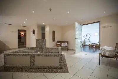 a living room with a table and chairs at Hotel Innerhofer in Gais