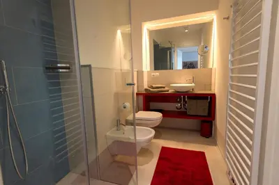 a bathroom with a toilet and a sink and a shower at App110 in Merano