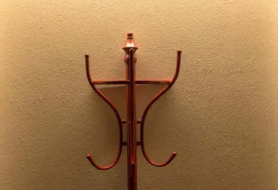 a metal object is hanging on a wall at App110 in Merano
