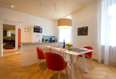 a kitchen and dining room with a table and chairs at App110 in Merano