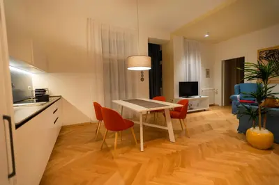 a kitchen and living room with a table and chairs at App110 in Merano