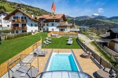 a villa with a swimming pool and a house at Der Brunnerhof in Mühlbach