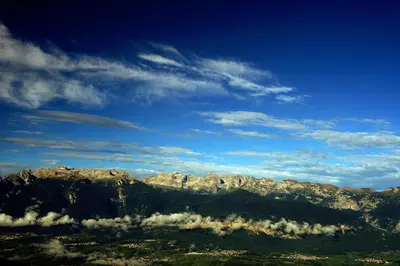 a view of a mountain range with clouds at Rifugio Predaia Ai Todes'ci in Tres