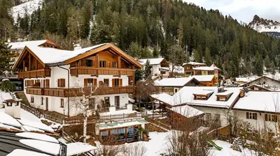 a ski lodge with snow on the roofs of houses at Apartments Samberg in Eggen