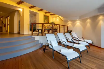 a waiting room with white chairs and stairs at Apartments Samberg in Eggen