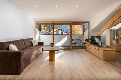 a living room with a couch and a tv at Apartments Samberg in Eggen