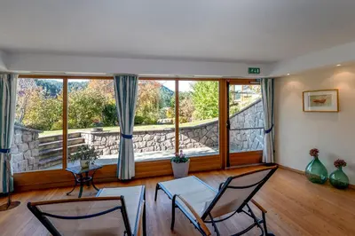 a living room with chairs and a large window at Apartments Samberg in Eggen