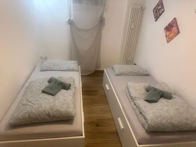 a bedroom with two beds with ties on them at Samy s Home 1 FREE parking Wi-Fi in Bolzano