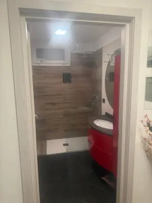 a bathroom with a red toilet and a sink at Samy s Home 1 FREE parking Wi-Fi in Bolzano