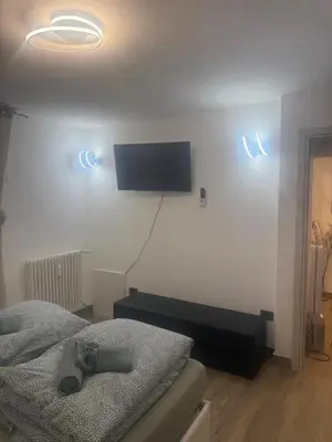 a bedroom with a bed and a tv on the wall at Samy s Home 1 FREE parking Wi-Fi in Bolzano