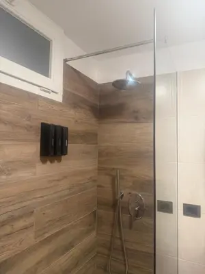 a shower with a glass door in a bathroom at Samy s Home 1 FREE parking Wi-Fi in Bolzano