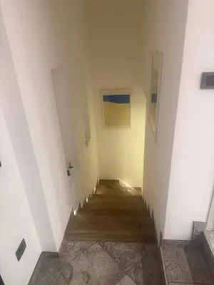 a hallway with white walls and wooden floors at Samy s Home 1 FREE parking Wi-Fi in Bolzano