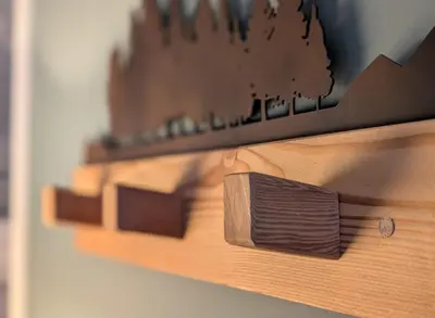 a close up of a knife on a wooden shelf at Casa al Duomo - Domhaus in Bolzano