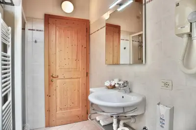 a bathroom with a sink and a mirror at Hotel Garni Civetta in Selva di Cadore